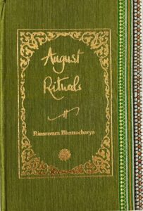 A sample cover of the book: olive green coloured sari with gold embossed nameplate and lettering for the title and author's name. The border of the sari lines the right hand margin of the cover.