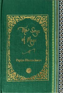 A sample cover of the book: bright green coloured handloom sari with gold embossed nameplate and lettering for the title and author's name. The border of the sari lines the right hand margin of the cover.