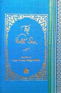 A sample cover of the book: sky-blue handloom sari with gold embossed nameplate and lettering for the title and author's name. The border of the sari lines the right hand margin of the cover.