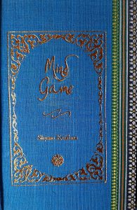 A sample cover of the book: sky-blue handloom sari with gold embossed nameplate and lettering for the title and author's name. The border of the sari lines the right hand margin of the cover.