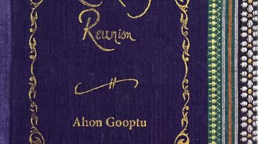 A sample cover of the book: midnight blue handloom sari with gold embossed nameplate and lettering for the title and author's name. The border of the sari lines the right hand margin of the cover.