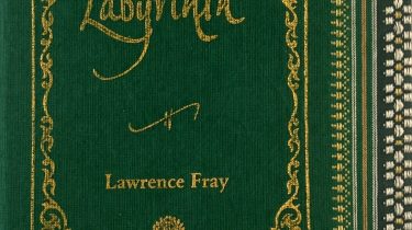 A sample cover of the book: green handloom sari with gold embossed nameplate and lettering for the title and author's name. The border of the sari lines the right hand margin of the cover.